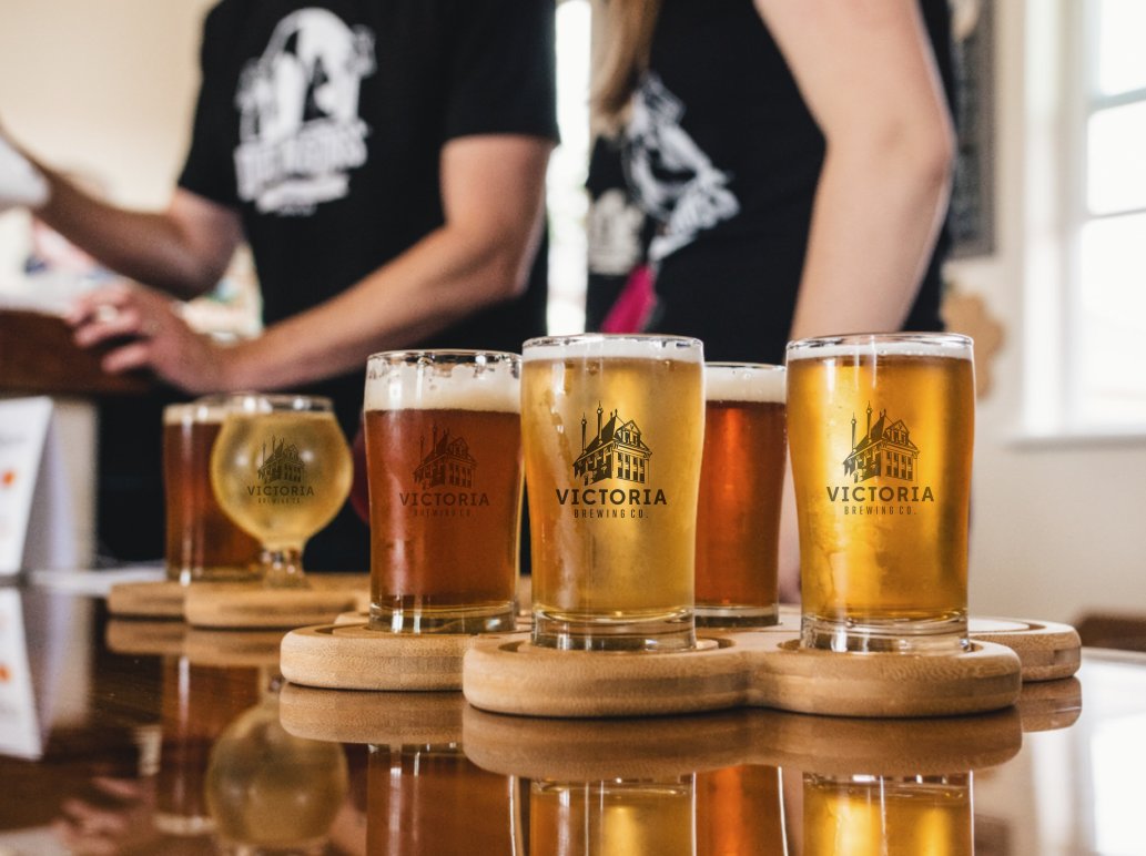 A flight of Victoria Brewing Co. beers on a tasting paddle